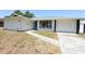 Charming home featuring a bright blue front door and a well-maintained front yard at 108 Sandburg Ln, Winter Haven, FL 33884