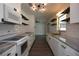 Modern kitchen with white cabinetry, subway tile backsplash, and floating wood shelves at 108 Sandburg Ln, Winter Haven, FL 33884