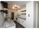 Well-lit kitchen featuring white cabinets, granite countertops, and modern lighting fixtures at 108 Sandburg Ln, Winter Haven, FL 33884