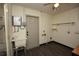 Functional laundry room equipped with a utility sink, storage solutions, and an adjacent door at 108 Sandburg Ln, Winter Haven, FL 33884