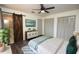 Stylish main bedroom boasts wood-look flooring, barn door to ensuite, and ample closet space at 108 Sandburg Ln, Winter Haven, FL 33884