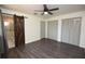 Spacious main bedroom features wood-look flooring, and a barn door leading to the ensuite bathroom at 108 Sandburg Ln, Winter Haven, FL 33884