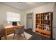 Cozy office space features a well-lit desk area, open shelving, and a closet for added storage at 108 Sandburg Ln, Winter Haven, FL 33884