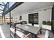 Covered patio featuring an outdoor dining table and a seating area at 108 Sandburg Ln, Winter Haven, FL 33884
