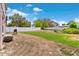 Expansive backyard showing white fence, barbecue grill, and grassy and bare areas at 11 W Bay St, Davenport, FL 33837