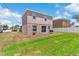 Backyard featuring grassy lawn and white fence, with a barbecue grill and plenty of space at 11 W Bay St, Davenport, FL 33837