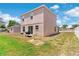 Spacious backyard with grass, white fence, and barbecue grill, perfect for outdoor living at 11 W Bay St, Davenport, FL 33837