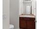 Powder room with a vanity, sink, and a dark wood cabinet at 11 W Bay St, Davenport, FL 33837