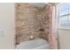 Bathroom featuring a bathtub with a tiled shower wall, and decorative floral shower curtain at 11 W Bay St, Davenport, FL 33837