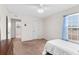 Cozy bedroom featuring a ceiling fan, window, and doorway to adjacent space at 11 W Bay St, Davenport, FL 33837