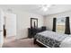 Cozy bedroom featuring a black dresser, ceiling fan, and a window for natural light at 11 W Bay St, Davenport, FL 33837