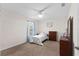Bright bedroom with natural light, ceiling fan, and a charming dresser at 11 W Bay St, Davenport, FL 33837