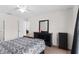 Cozy bedroom with neutral carpet, ceiling fan, and dark wood furniture at 11 W Bay St, Davenport, FL 33837