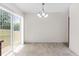 Bright dining area featuring tile floors, sliding glass doors, and modern chandelier at 11 W Bay St, Davenport, FL 33837