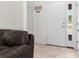 Bright foyer with white front door, side window, and a decorative welcome sign at 11 W Bay St, Davenport, FL 33837