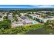 Aerial view of complex featuring tennis courts, a swimming pool, and proximity to a lake at 1130 N Lake Parker Ave # C321, Lakeland, FL 33805