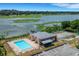 Aerial view of community pool, tennis court, and lake at 1130 N Lake Parker Ave # C321, Lakeland, FL 33805
