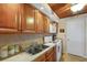 Efficient kitchen featuring warm wood cabinets, stainless steel sink, and modern appliances at 1130 N Lake Parker Ave # C321, Lakeland, FL 33805