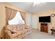 A cozy living room with comfortable floral sofa, neutral walls and window with blind at 1130 N Lake Parker Ave # C321, Lakeland, FL 33805