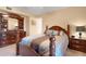 Well-appointed main bedroom with a comfortable bed and coordinating wood furniture at 1130 N Lake Parker Ave # C321, Lakeland, FL 33805
