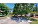A lovely backyard featuring a large tree, a table, and an outdoor shed at 1195 E George St, Bartow, FL 33830