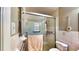 Bathroom with glass-enclosed shower and safety bars, ensuring accessibility and comfort at 1195 E George St, Bartow, FL 33830