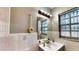 This bathroom features a single sink, light sconce, and window with white tile accents at 1195 E George St, Bartow, FL 33830