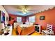 A cozy bedroom featuring hardwood floors, ceiling fan, decorative wall paper and furnishings at 1195 E George St, Bartow, FL 33830