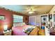 A well-lit bedroom features hardwood floors, ceiling fan, and view to the doorway and closet at 1195 E George St, Bartow, FL 33830