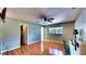 Spacious bedroom featuring hardwood floors, a ceiling fan, and natural light from the window at 1195 E George St, Bartow, FL 33830