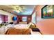 A brightly colored bedroom with hardwood floors, ceiling fan and furnishings at 1195 E George St, Bartow, FL 33830