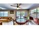 Cozy dining area with glass-top table, adjacent to a comfortable sitting area and outdoor access at 1195 E George St, Bartow, FL 33830