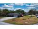 Spacious property with a well-kept lawn, a two-car garage, and an American flag waving proudly at 1195 E George St, Bartow, FL 33830