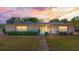 Charming home featuring stone accents, a well-manicured lawn, and a welcoming front entrance at 1195 E George St, Bartow, FL 33830