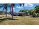 Charming single-story home featuring a well-manicured lawn, mature palm trees, and inviting curb appeal at 1195 E George St, Bartow, FL 33830