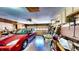 A cluttered two car garage with the car inside at 1195 E George St, Bartow, FL 33830