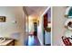 Hallway with wood floors and view to a display cabinet and the doorway at 1195 E George St, Bartow, FL 33830