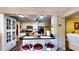 Modern kitchen with bar seating, white cabinets, and ample counter space for food preparation at 1195 E George St, Bartow, FL 33830
