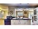 Open kitchen with bar, plenty of storage, and view to a casual dining area at 1195 E George St, Bartow, FL 33830