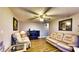 Cozy living room with comfortable seating, a ceiling fan and warm, inviting decor at 1195 E George St, Bartow, FL 33830
