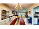 Open-concept living room and dining area with chandelier and seamless flow to the kitchen at 1195 E George St, Bartow, FL 33830