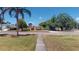 Street view of the home with a green lawn and mature trees, adding to its inviting presence at 1195 E George St, Bartow, FL 33830