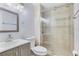 Bathroom featuring a modern vanity, toilet, and tiled shower with glass door at 1210 Marrick Cir, Lakeland, FL 33815