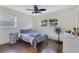 Bright bedroom featuring hardwood floors, two windows, ceiling fan, and gray walls at 1210 Marrick Cir, Lakeland, FL 33815