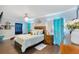 Comfortable bedroom featuring a queen-sized bed, soft lighting, and stylish turquoise accents at 1210 Marrick Cir, Lakeland, FL 33815