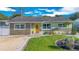 Charming single-story home features a bright yellow front door, stone accents, and a well-maintained lawn at 1210 Marrick Cir, Lakeland, FL 33815