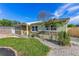 Inviting single-story home with stone accents, a vibrant green lawn, and lush palm trees enhancing its curb appeal at 1210 Marrick Cir, Lakeland, FL 33815