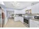 Bright kitchen featuring white cabinets, stainless steel appliances, granite countertops, and modern fixtures at 1210 Marrick Cir, Lakeland, FL 33815