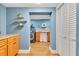 Hallway view of a laundry room featuring a washer, dryer, and decorative shelves at 1210 Marrick Cir, Lakeland, FL 33815