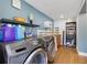 Laundry room featuring a washing machine, sink, and dark wood cabinets at 1210 Marrick Cir, Lakeland, FL 33815